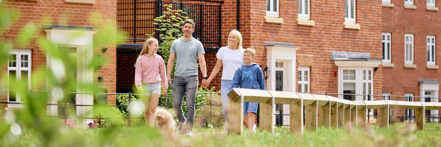 Famliy of four walking outside a house