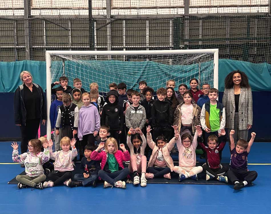 Some of the children taking part in the Blue Flames' Easter holiday club, along with (left) operations director Amy Rutherford and (right) Jamilah Hassan of the Banks Group