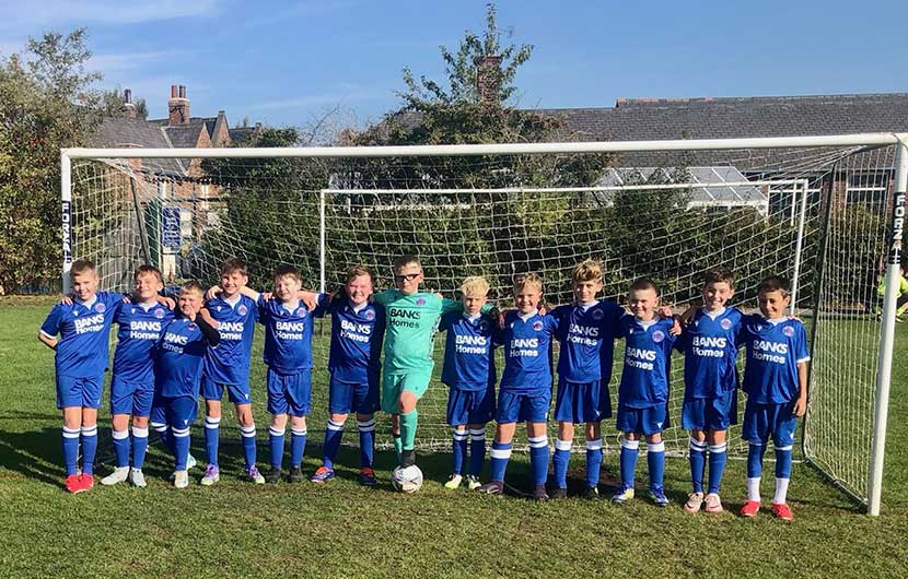 Members of the Malt Shovel Football Club U11s proudly wearing their new Banks Homes-sponsored kit